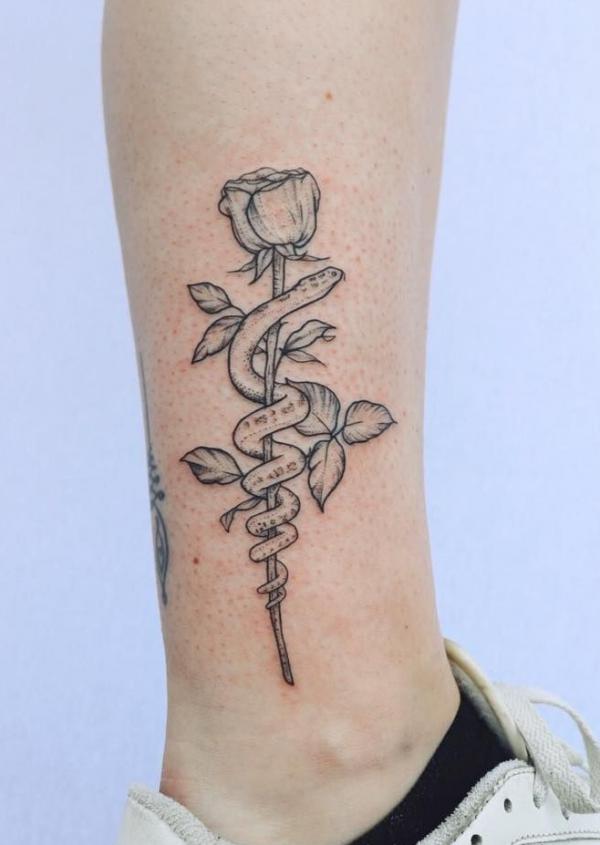 rose and snake tattoo above ankle