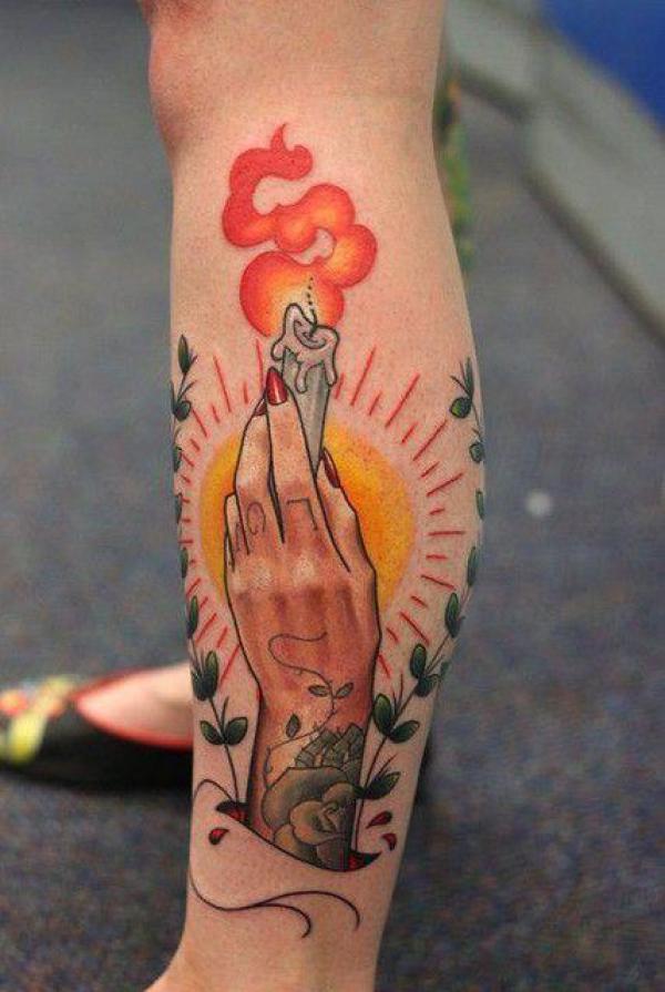 A hand holding candle with smoke tattoo traditional