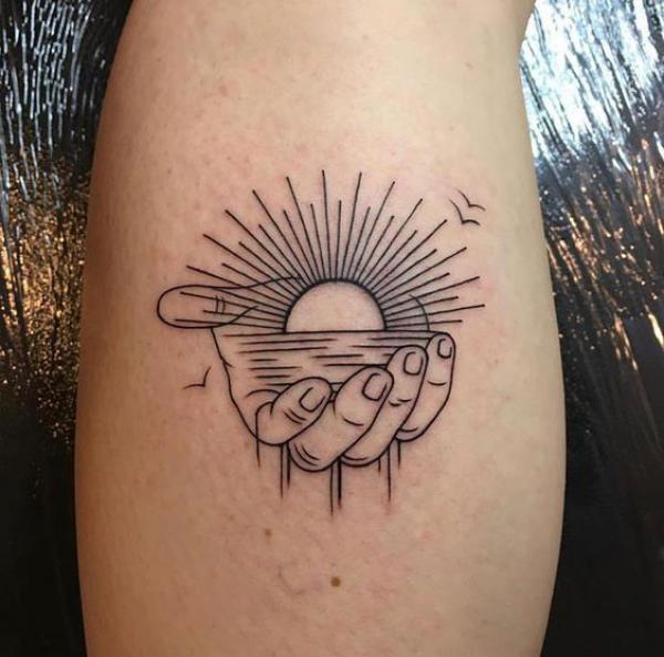 A sun holding a rising sun and ocean line work tattoo
