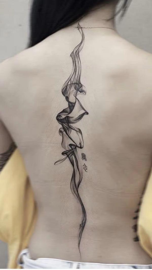 Abstract smoke spine tattoo