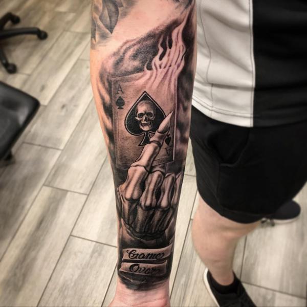 Ace of spade and skeleton hand tattoo