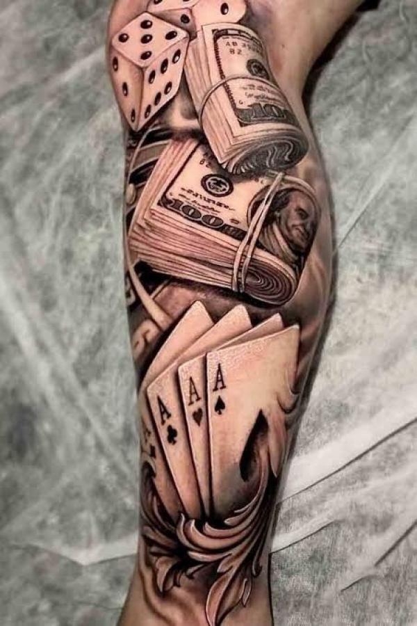 Ace of spade money and dice tattoo lower leg