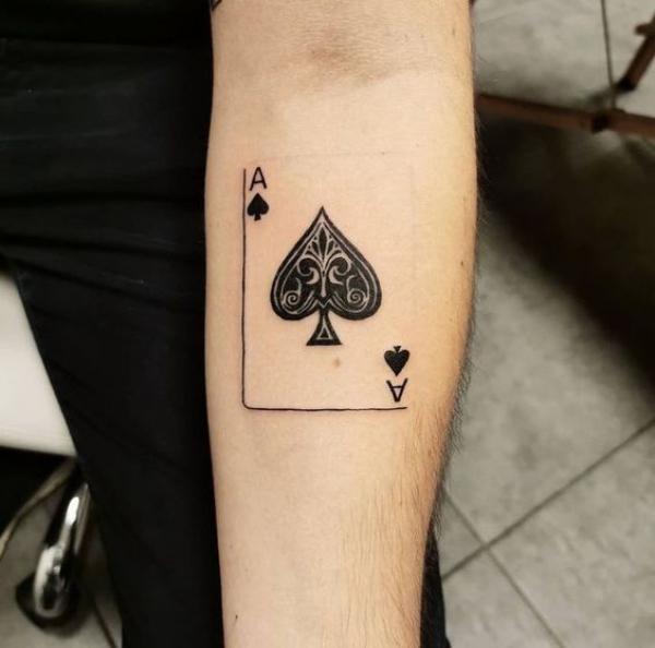 Ace of spade tattoo on inner forearm