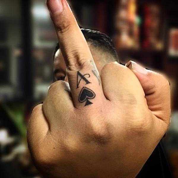Ace of spade tattoo on middle finger