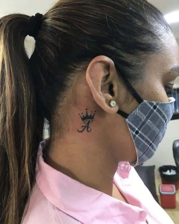 Ace of spade with crown tattoo behind ear