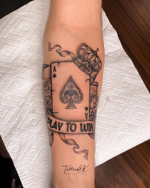 Ace of spades with crown tattoo with words Pay to Win