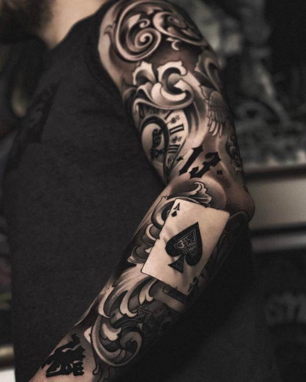 Ace of spades with number 13 and swirls tattoo sleeve