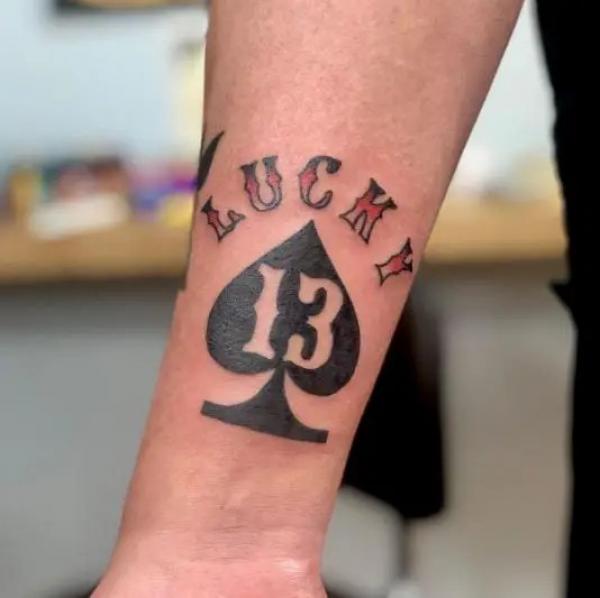 Ace of spades with number 13 tattoo