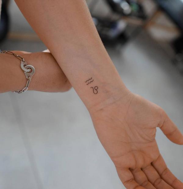 Aquarius and Leo signs tattoo on wrist