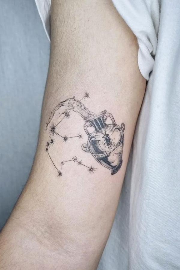 Aquarius bicep tattoo