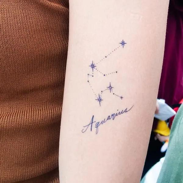 Aquarius constellation and lettering tattoo