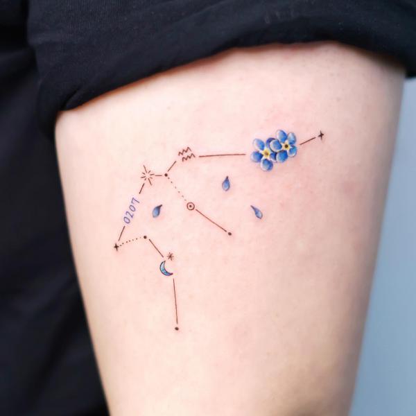 Aquarius constellation with forget me not tattoo