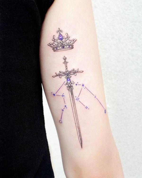Aquarius constellation with sword and crown tattoo