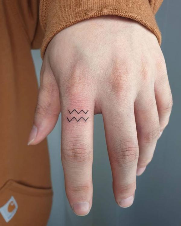Aquarius finger tattoo