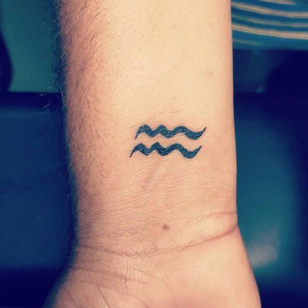 Aquarius gliph tattoo wrist