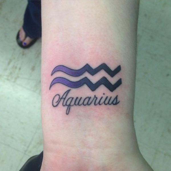 Aquarius sign and script tattoo wrist