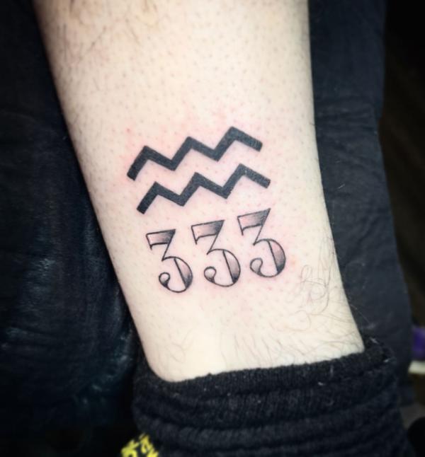Aquarius sign with the number 333 tattoo