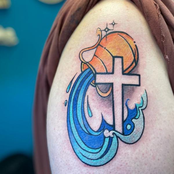 Aquarius water bearer and cross tattoo