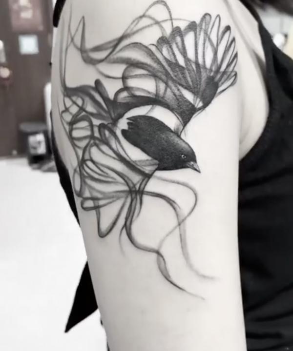 Bird with smoke tattoo