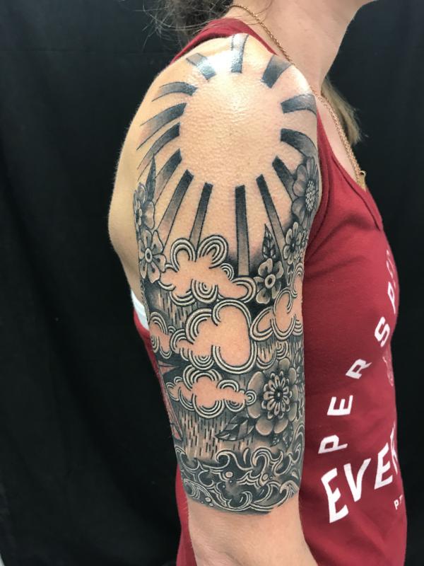 Black and white Japanese sun tattoo shoulder