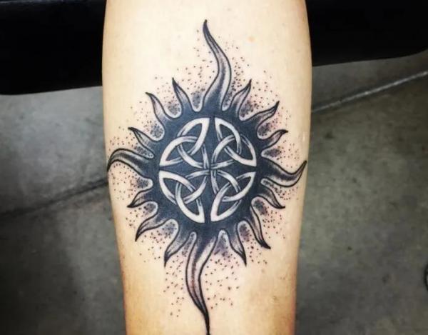 Black and white celtic sun tattoo