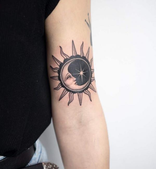 Black and white sun and moon face tattoo