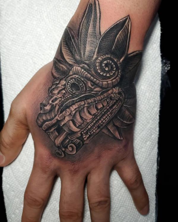 Blackwork Quetzalcoatl tattoo hand