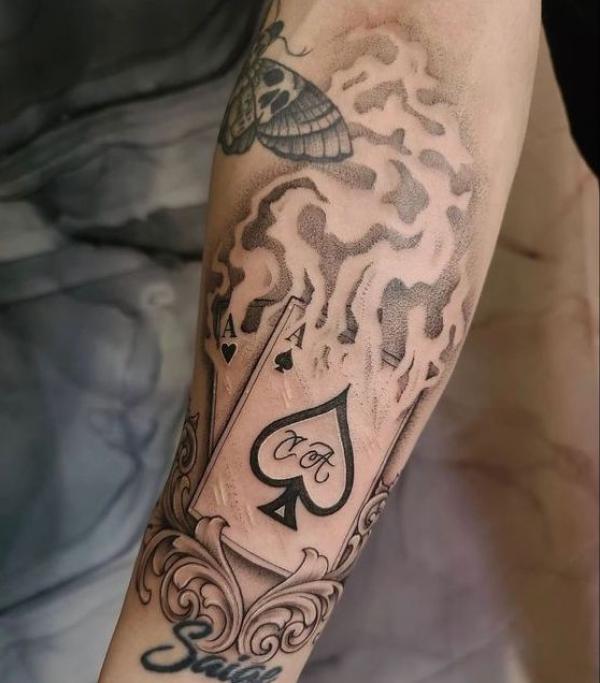 Burning Ace of spade forearm tattoo