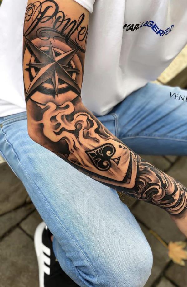 Burning ace of spade and compass tattoo