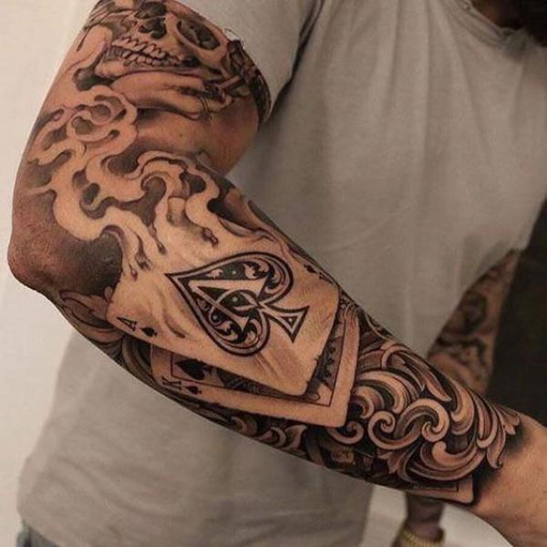 Burning ace of spade tattoo forearm