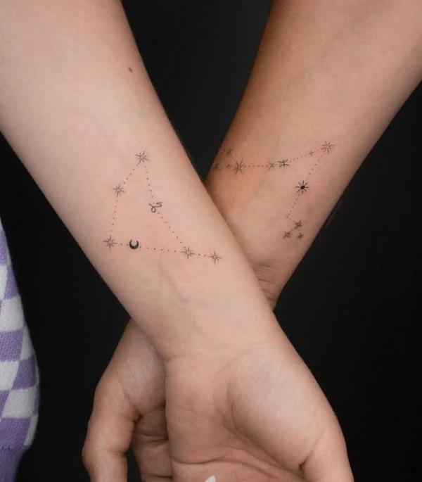 Capricorn and Pisces constellation matching tattoos forearm