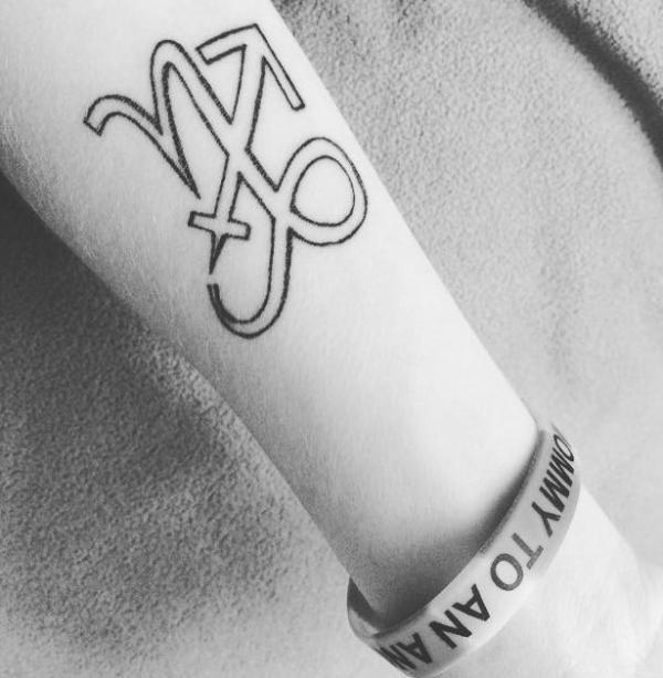 Capricorn and sagittarius signs tattoo forearm