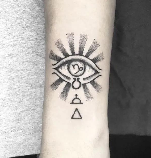 Capricorn eye tattoo forearm