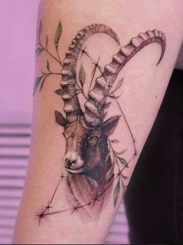 Capricorn goat and constellation with leaves tattoo