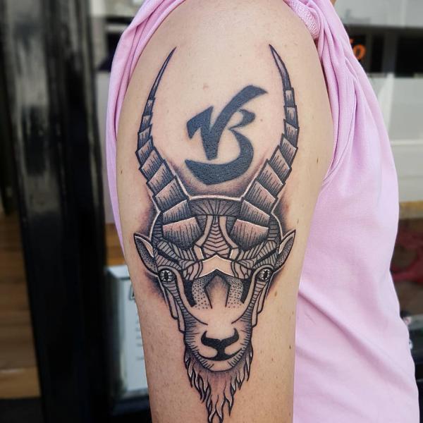 Capricorn goat head with glyph tattoo half sleeve