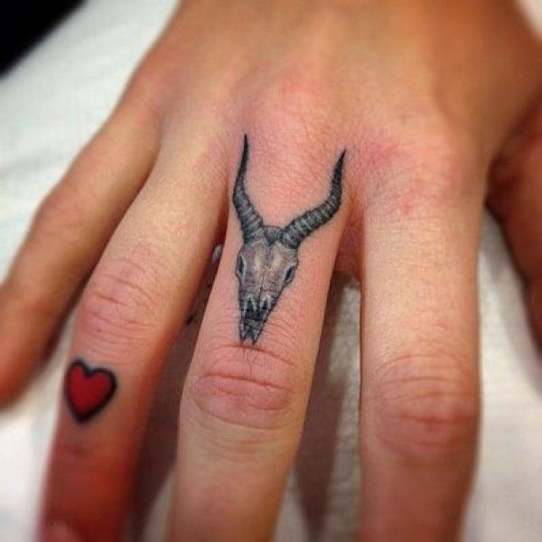 Capricorn goat skull tattoo on finger