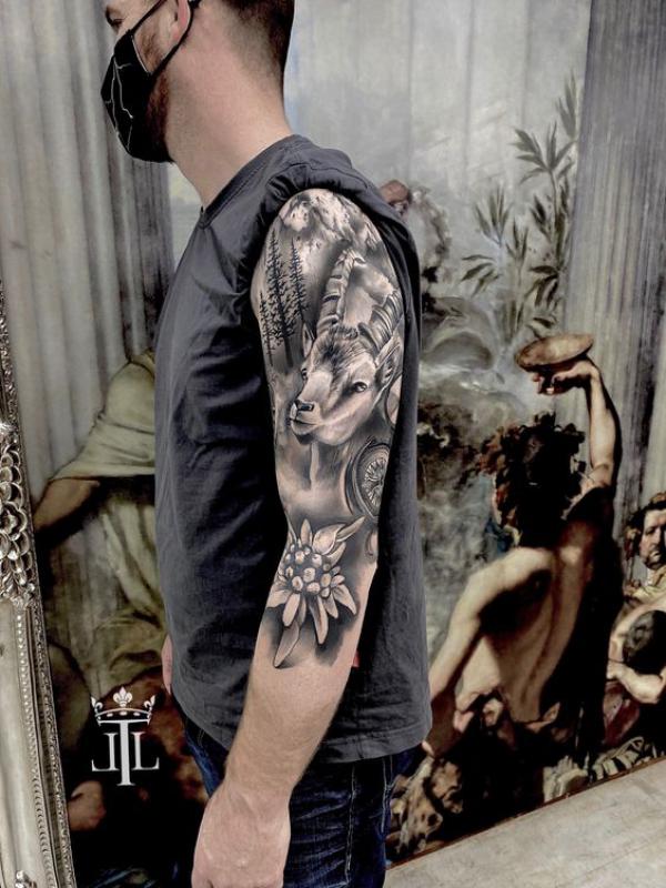 Capricorn goat with mountain tree and edelweiss flower tattoo