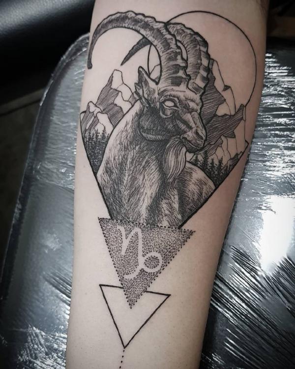 Capricorn goat with sign tattoo forearm