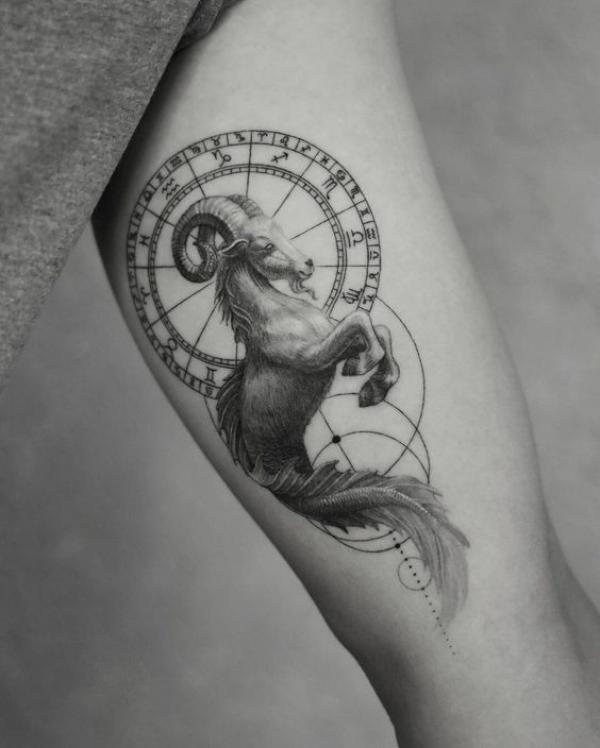 Capricorn sea goat and Zodiac wheel tattoo bicep