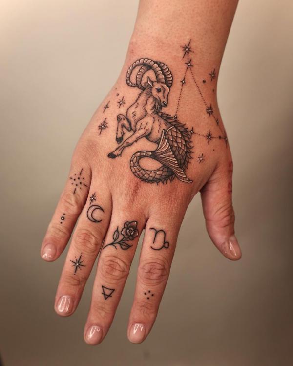 Capricorn sea goat and constellation hand tattoo