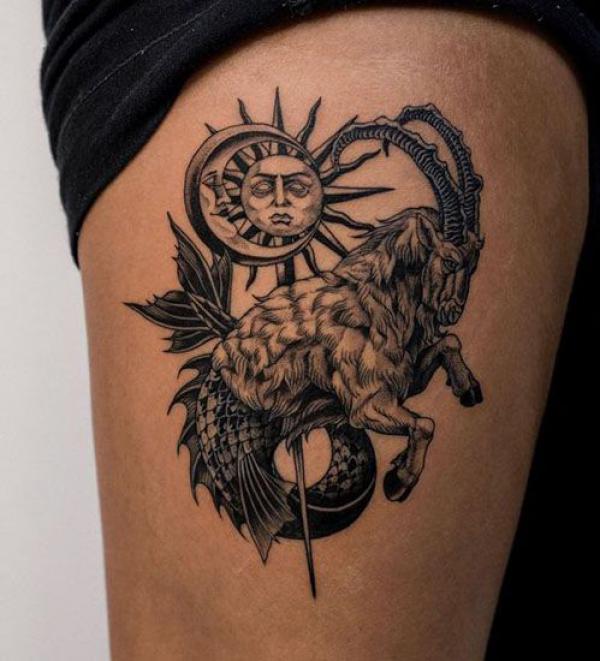 Capricorn sea goat and sun with moon tattoo thigh