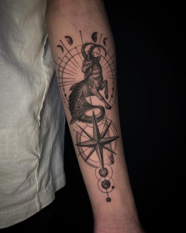 Capricorn sea goat with moon phases and compass tattoo