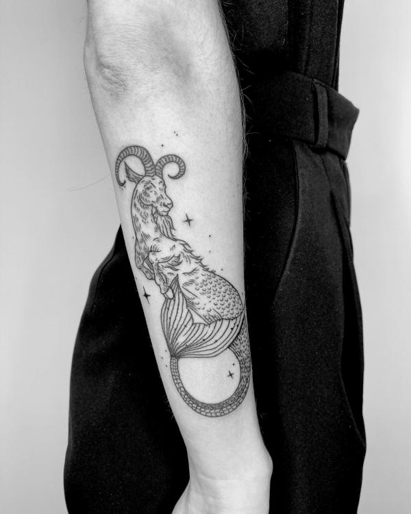 Capricorn sea goat with stars tattoo forearm