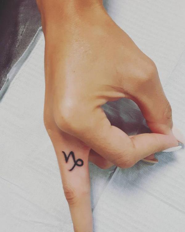 Capricorn sign finger tattoo