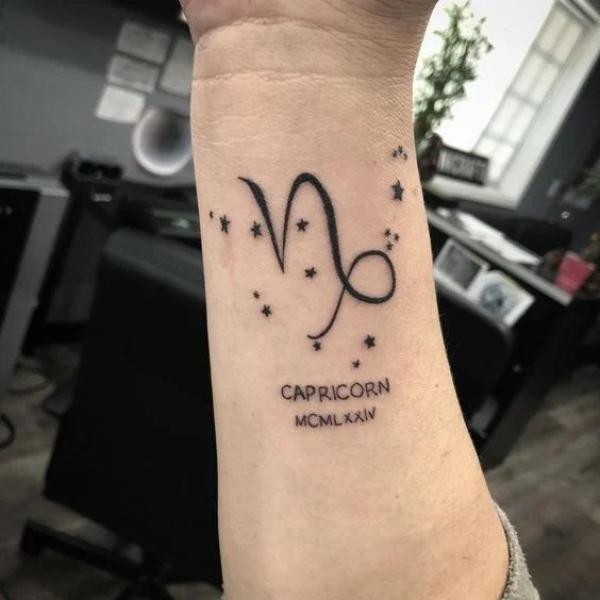 Capricorn with Roman numeral tattoo