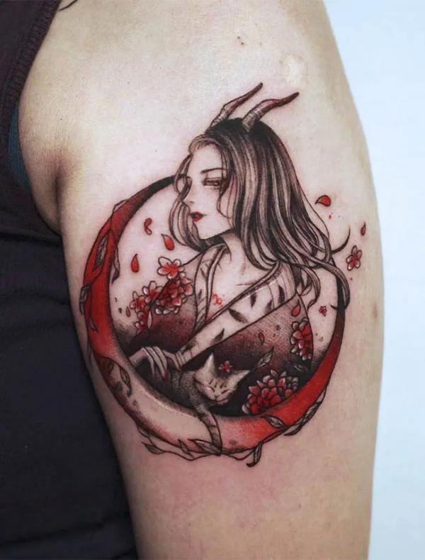 Capricorn woman with crescent moon tattoo shoulder