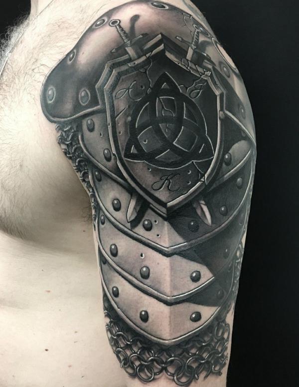 Celtic shield with two daggers tattoo