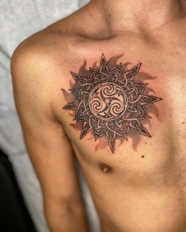 Celtic sun chest tattoo for men