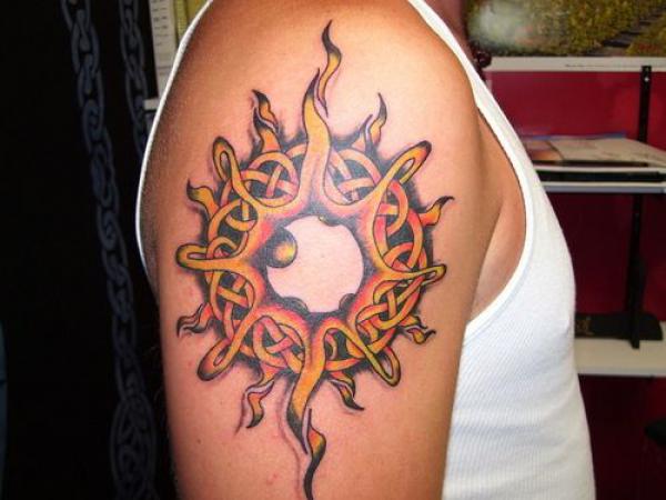 Celtic sun tattoo on shoulder
