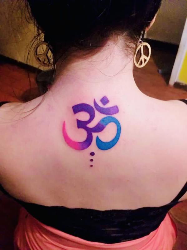 Colored OM nape tattoo